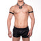 Person wearing black leather shorts and arm cuffs with a chain necklace on a white background