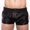 Black leather shorts worn by a person on a white background