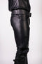 Black leather pants worn by a person on a white background