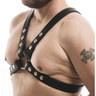 Black leather harness worn by a person on a white background