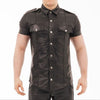 Man wearing a black leather shirt with silver buttons on a white background